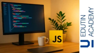 escritorio con monitor mostrando líneas de código coloridas, logo de JavaScript, taza y planta bajo luz cálida